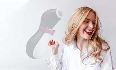 Clitoral satisfyer toy and a woman smiling